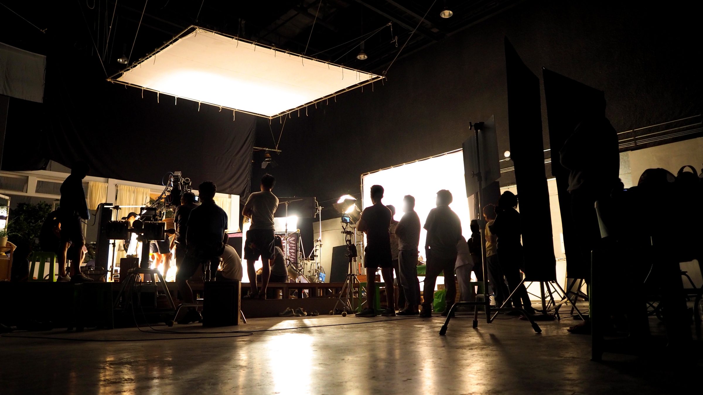 Video production crew filming behind the scenes