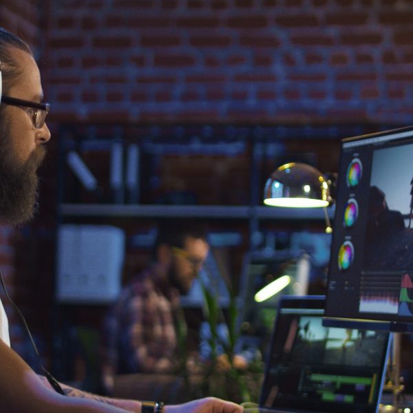 Side,View,Of,Casual,Man,In,Headphones,Working,On,Computer