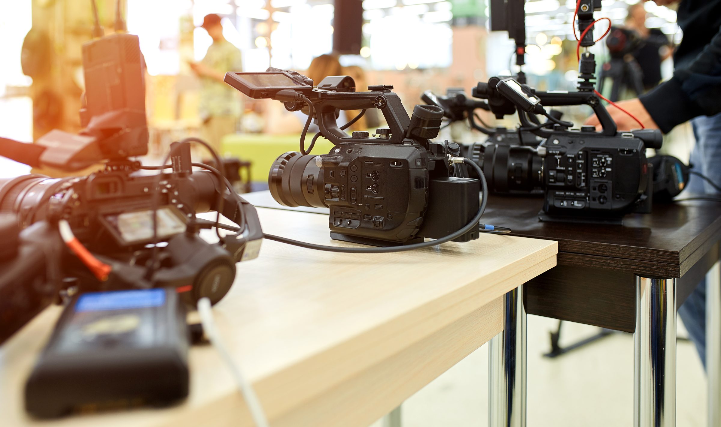 Behind the scenes of a corporate video production shoot with crew and lighting