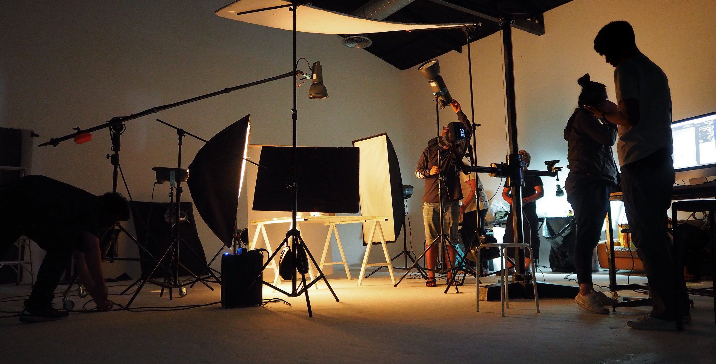 Behind the scenes silhouette of a production crew filming
