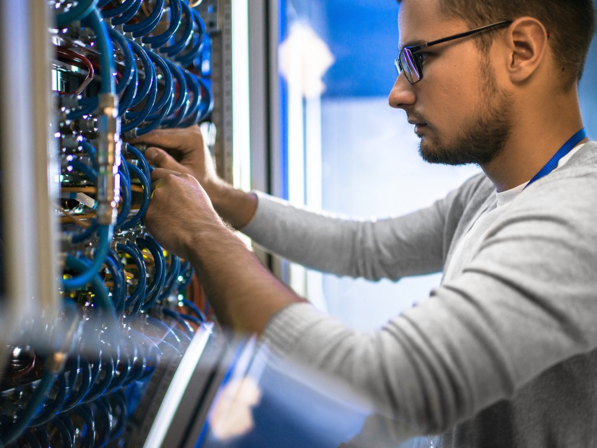 Side,View,Portrait,Of,Young,Man,Wearing,Glasses,Connecting,Cables