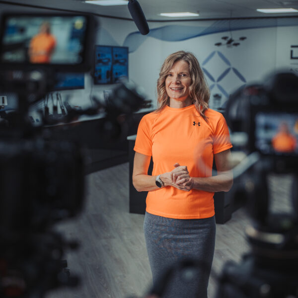 Corporate video production interview setup with multiple cameras and boom microphone in a UK office