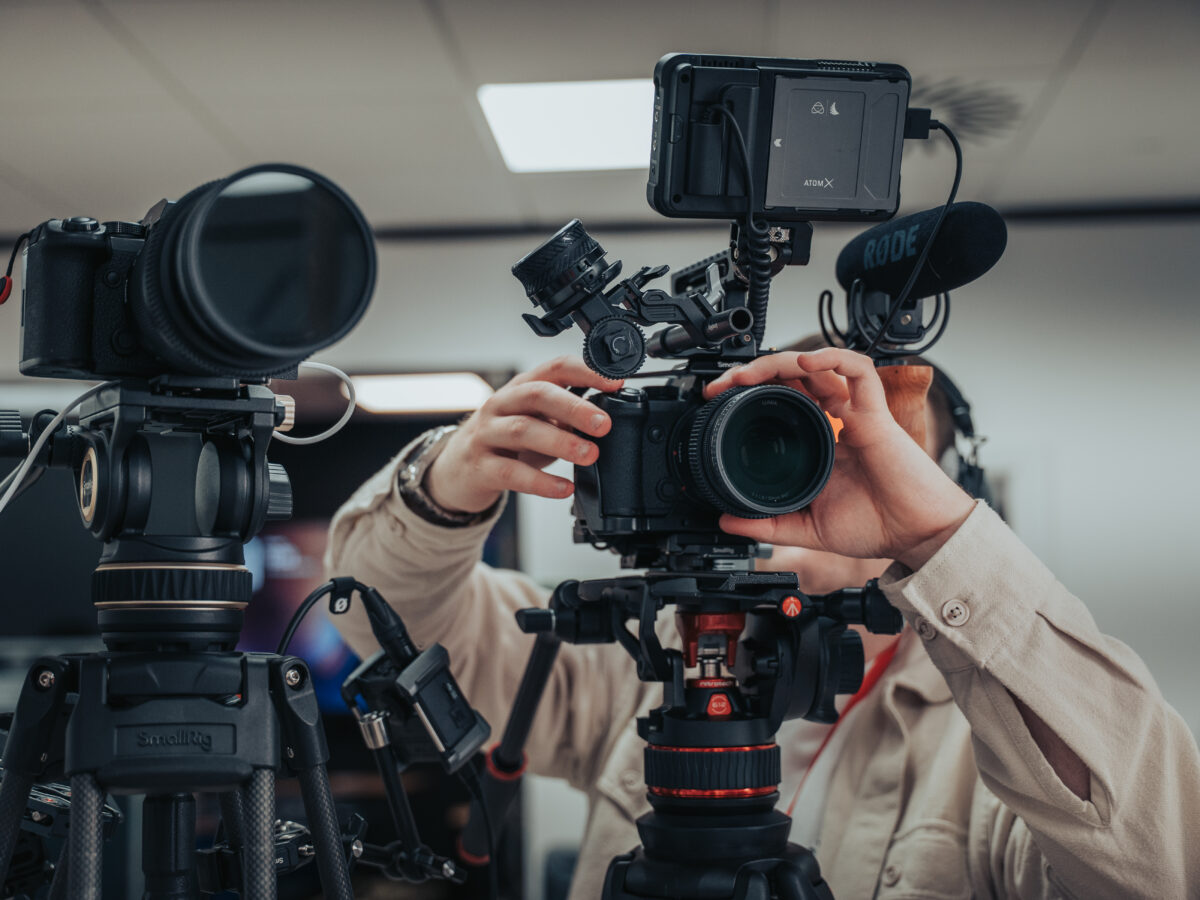 Video production camera crew setting up two cameras in a Southampton studio for a corporate shoot
