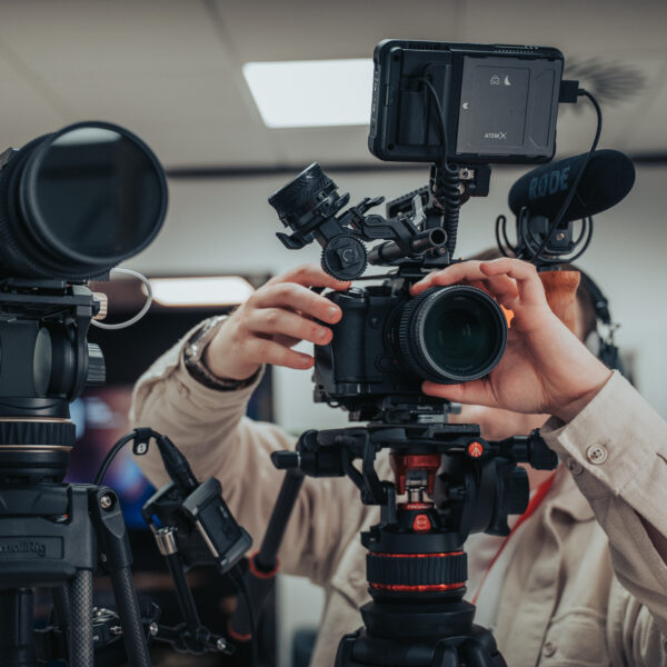 Video production camera crew setting up two cameras in a Southampton studio for a corporate shoot