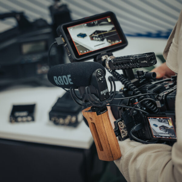 Videographer holding Sony FX camera with Rode microphone and monitor in Southampton studio