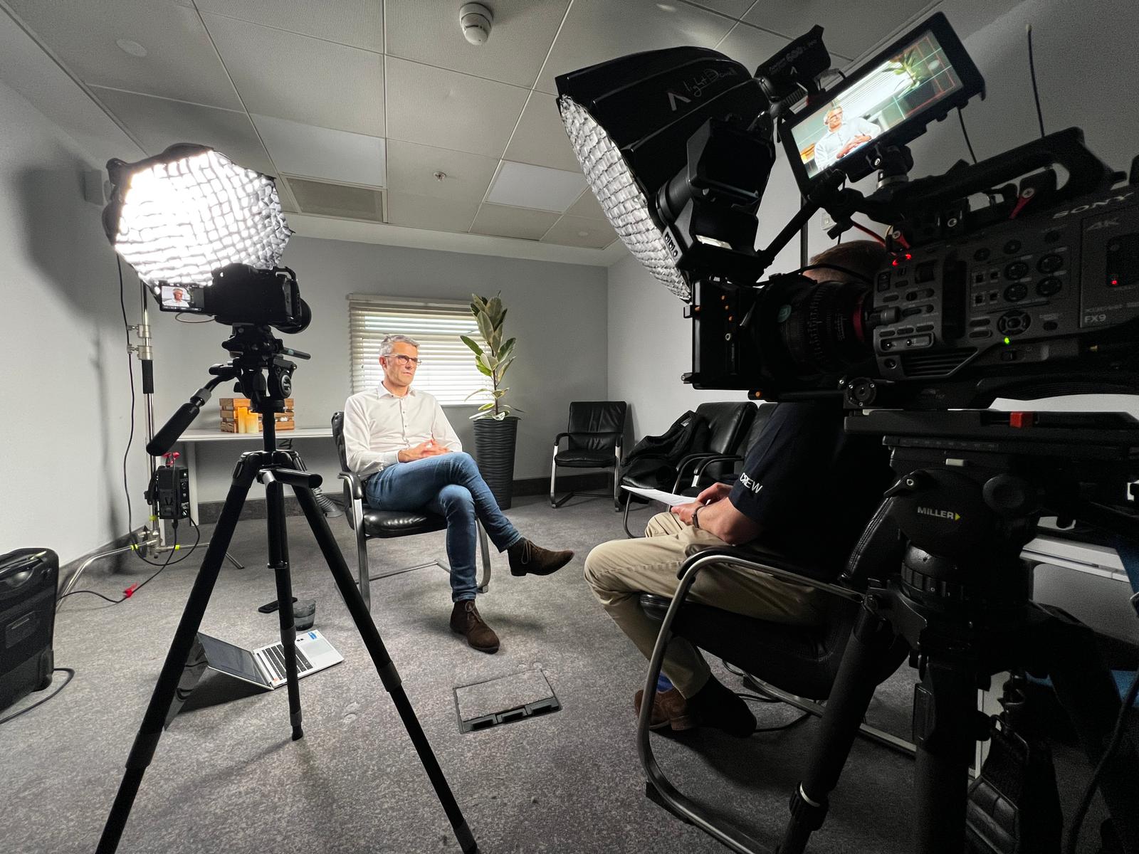 Two-camera corporate video interview in progress with softbox lighting at a Zealous Media shoot