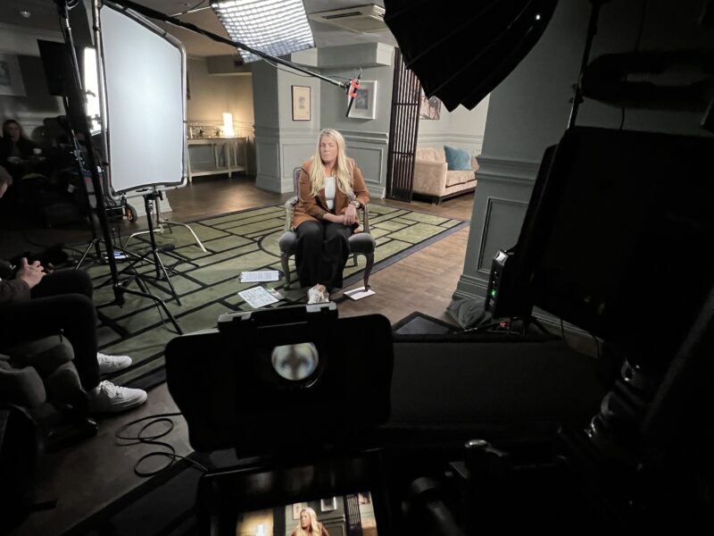 Behind the scenes filming a presenter interview in elegant room - Zealous Media