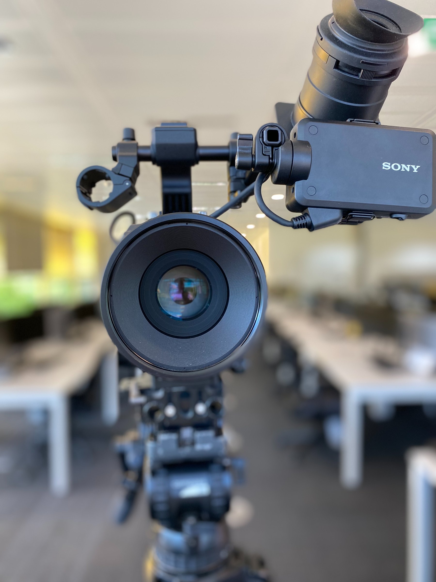 Sony camera with gimbal stabiliser and external microphone mounted on professional video production tripod