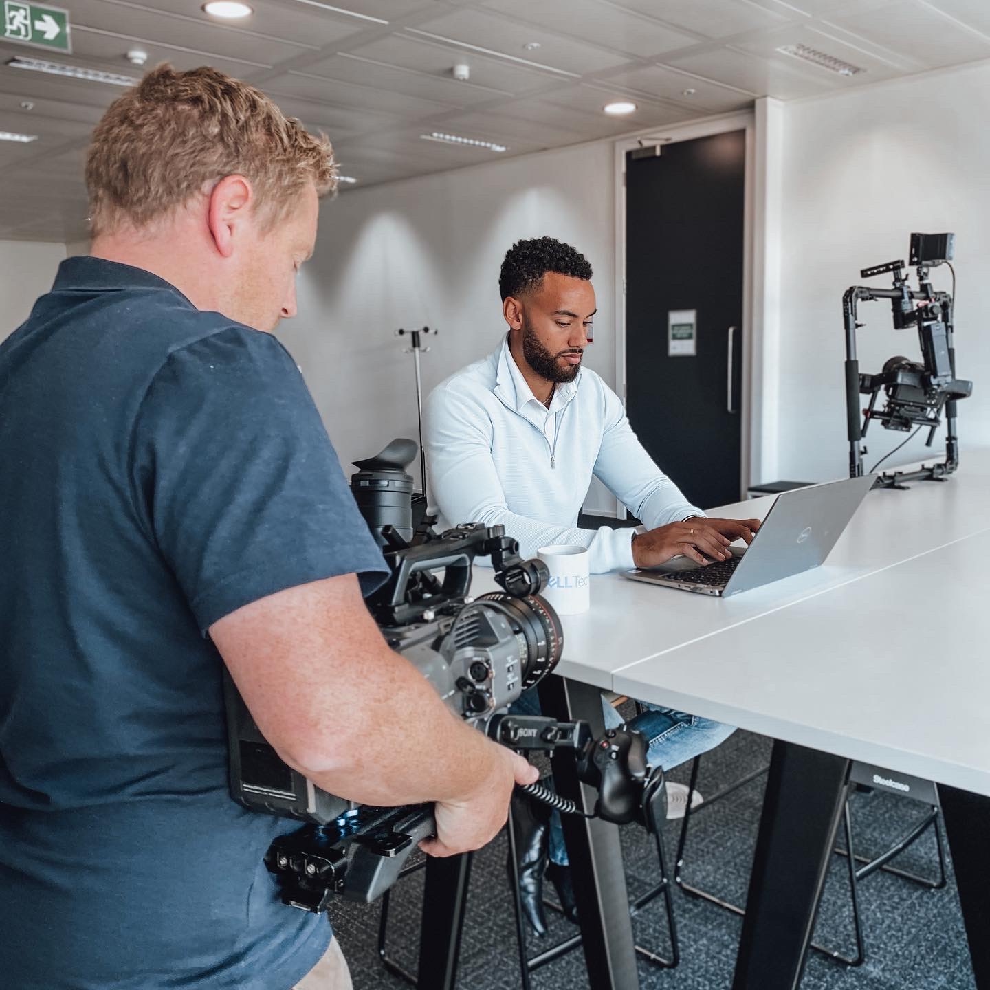 Cameraman filming corporate interview handheld